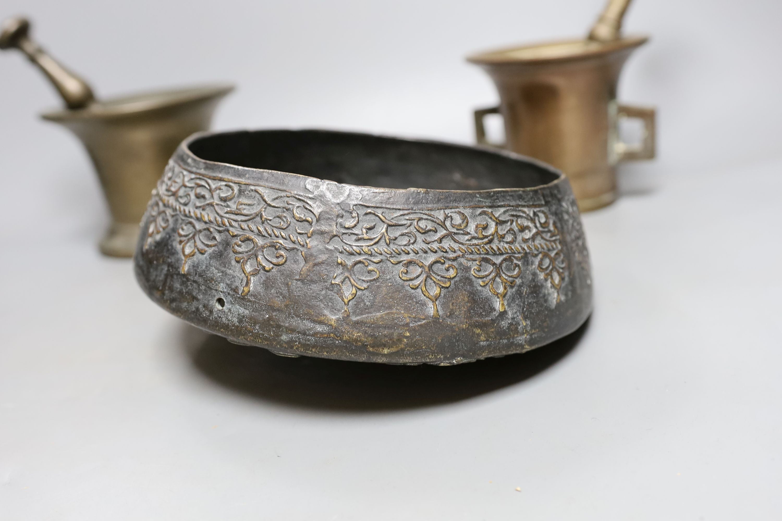 Two pestles and mortars and a Chinese gong with beater, gong 21 cms wide.